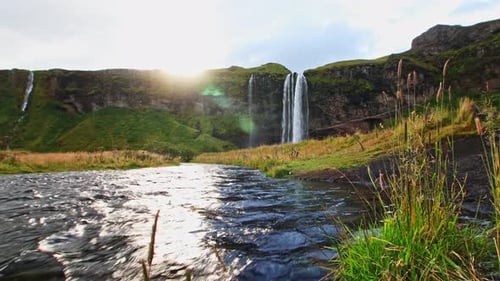 Low view shot from the stream of Seljalandfoss one of the most beautiful waterfall in iceland in sum