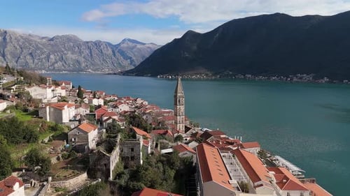 4K drone footage captures Saint Nicholas Church in the charming town of Perast, Montenegro, with a b