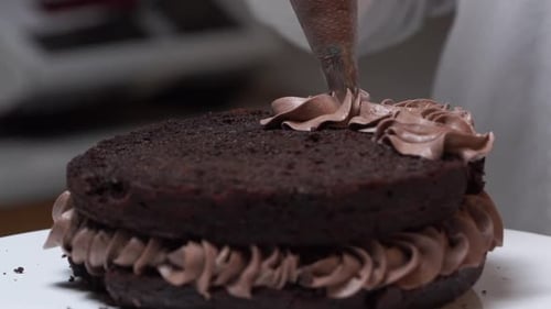 wipping cream on second layer of choccalate cake