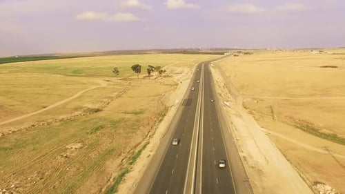 Asphalt road along a dry desert landscape