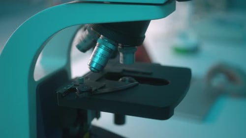 Close up shot of automated scientific laboratory microscope examining sample. Stock footage. Science