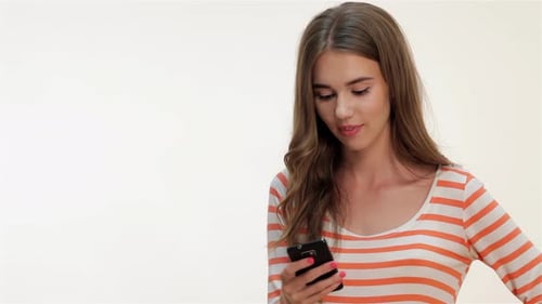 Smiling Woman Using Cellphone Device in Studio