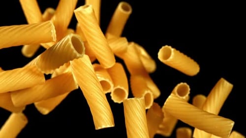 Studio Shot of Rigatoni Pasta Floating on Black