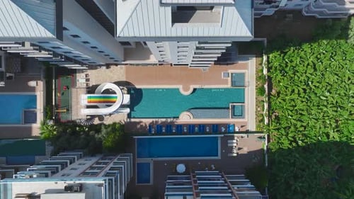 Aerial View Modern Complex With Pool and Water Slides for Kids on the Mediterranean Coast