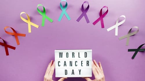 Hands Holding Sign for World Cancer Day