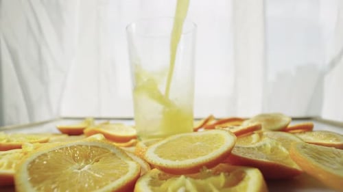 Pouring Fresh Orange Juice into a Glass