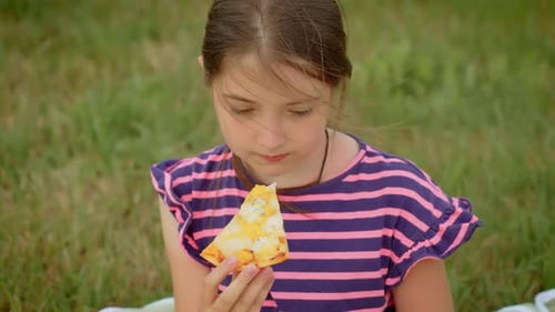 Happy Girl Eating Homemade Pizza During Family Picnic at Field Joyful Child Enjoying Cheesy Homemade