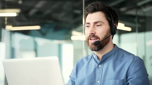 Confident operator who works in customer support speaks on a video call using a laptop. Call center