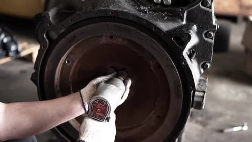 Mechanic Working on Engine with Tool Close Up