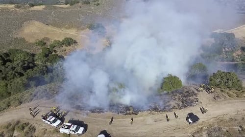 The contained fire slowly burns down the hill