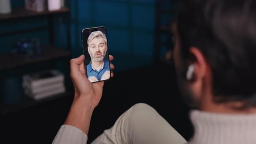Man Video Chats With Friend on Smartphone