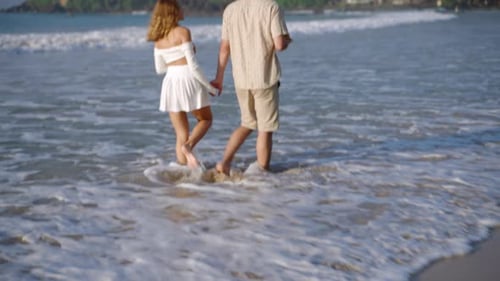 Boyfriend Girlfriend Walking Barefoot in Sea Surf Waves Runs Splashing Water Young Couple Talks