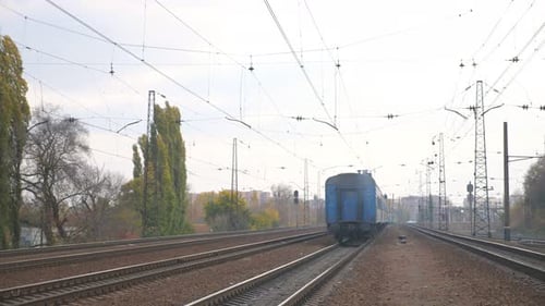 Rear View of Passenger Train Leaving a Station During Transporting People Railway Transport