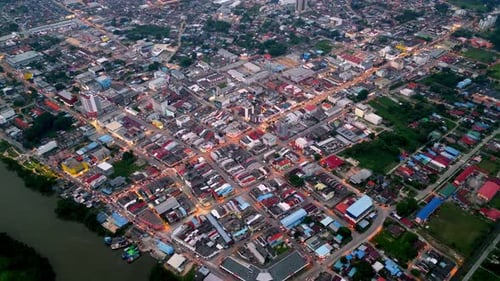 A city with a river running through it. Aerial Batu Pahat town in night