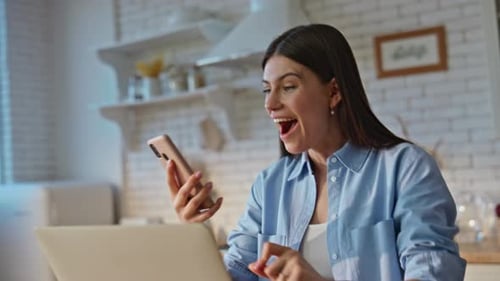 Happy Lady Winning Lottery Receiving Mobile Phone Notification at Home Closeup