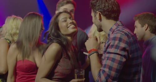 Group of friends in a club or bar dancing