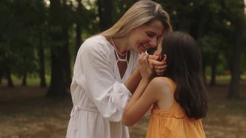 Mother and Daughter Share a Tender Moment in the Park