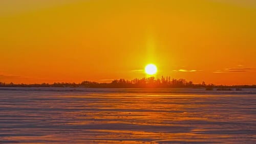Golden Sunset Over Frozen Winter Landscape