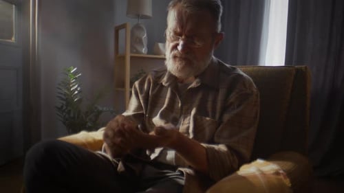 Senior Man Taking Medicine with Water Indoors