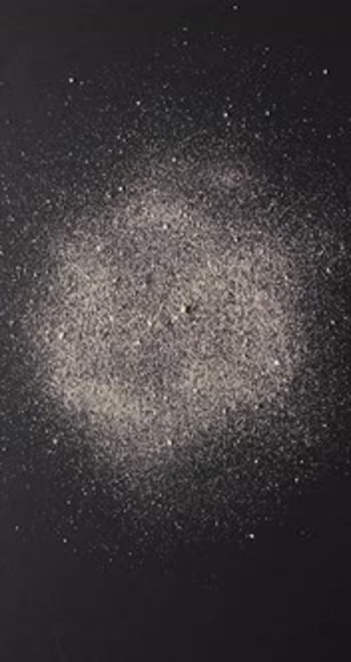 Vertical video of close up of sand grains and copy space on black background