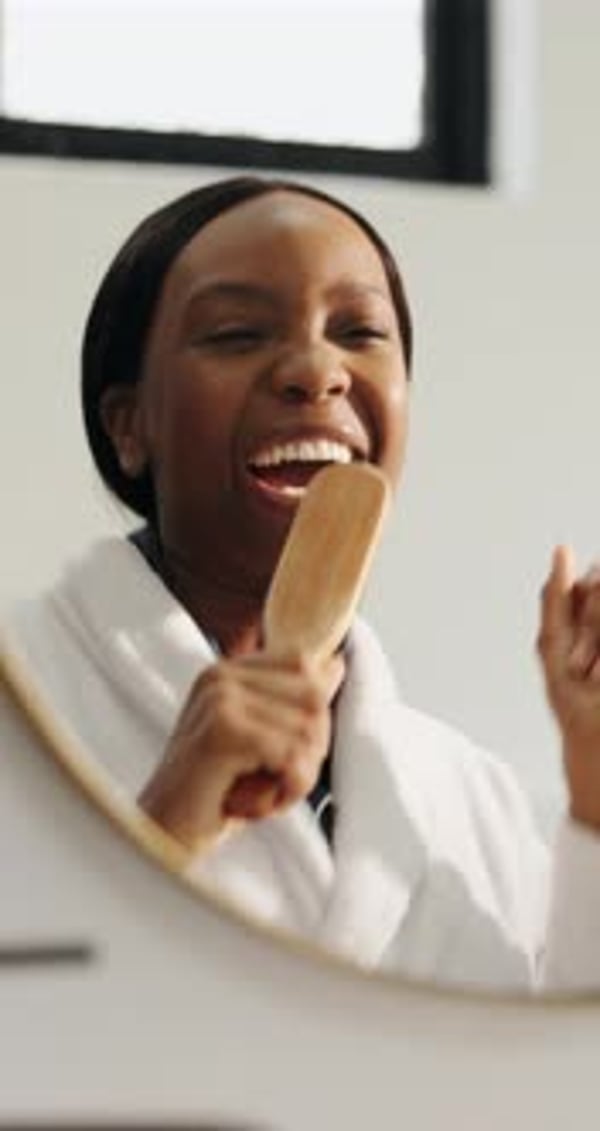 Mirror, hair brush and black woman singing in bathroom for morning ...