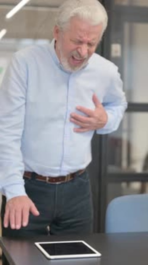 Old Businessman having Cardiac Arrest with Chest Pain in Office, vertical video