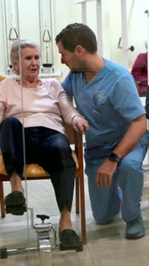 Elderly Patients Exercising Legs with Pedal Exerciser in Nursing Home