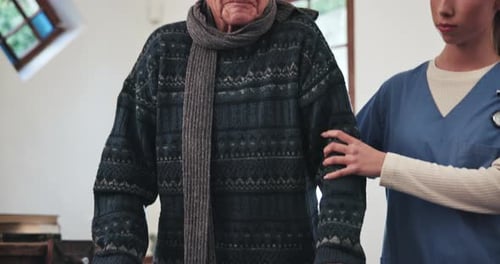 Nurse Helping Senior Man Use Walker Indoors