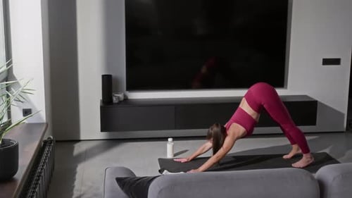Woman Doing Yoga Flow on Exercise Mat Indoors