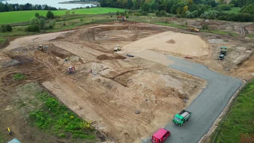 A drone flyover of a construction site, with visible and building foundations being created