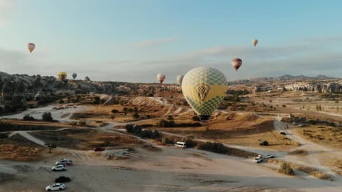 Hot Air Balloons Above Cappadocia Desert Landscape