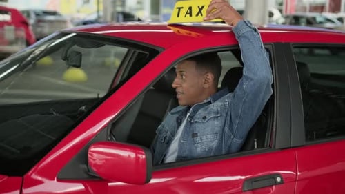 Taxi Driver in Red Car Gives Thumbs Up