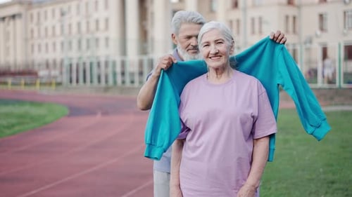 Loving Senior Couple Sharing Active Moment Outdoors