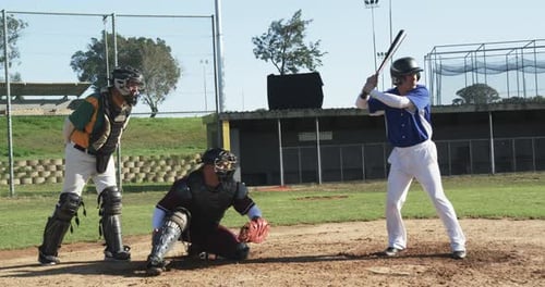 Batter Hits Baseball on Baseball Field