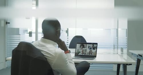 Man Attends Virtual Meeting in Modern Office