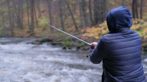 Fisherman Fishing in a River in the Forest