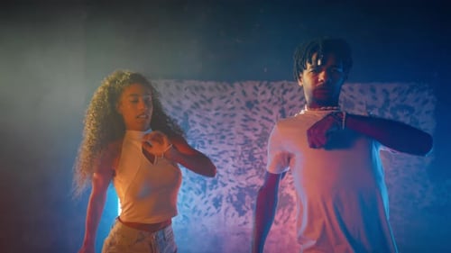 Young Man and Woman Energetically Dancing Together