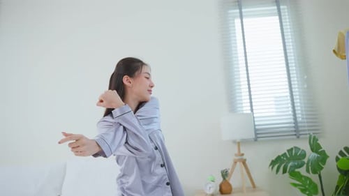 Woman Stretches, Selects Outfit in Bedroom