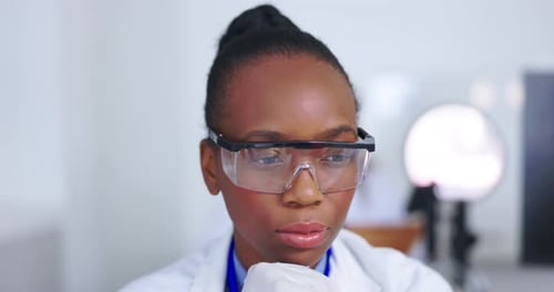Woman Scientist Using Microscope in Medical Laboratory