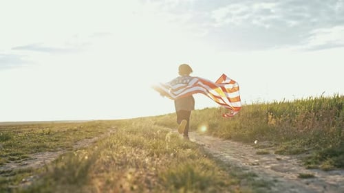 Child Runs with American Flag Through Field