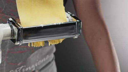 Slicing pasta into spaghetti