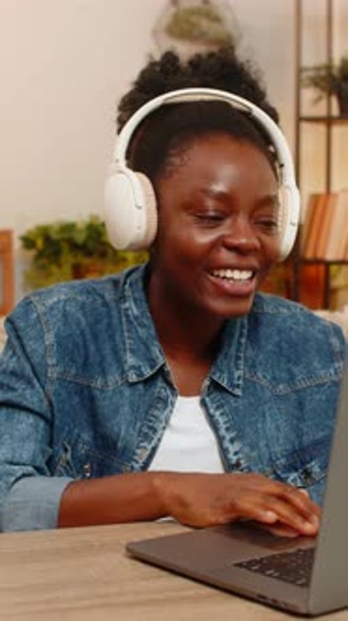 Smiling Woman Enjoys Video Call on Laptop at Home