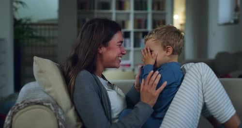 Portrait of Young Woman Playing a Game of Peak-a-boo with her Little Boy During Evening