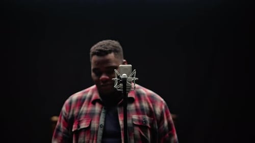 A Singer Standing Behind A Pianist In A Studio