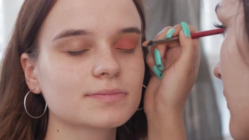 Makeup Artist Applying Makeup to Model's Face Close Up View