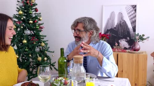 Family Laughing Together During a Christmas Meal