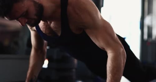 Man Doing Slow Push Ups at the Gym