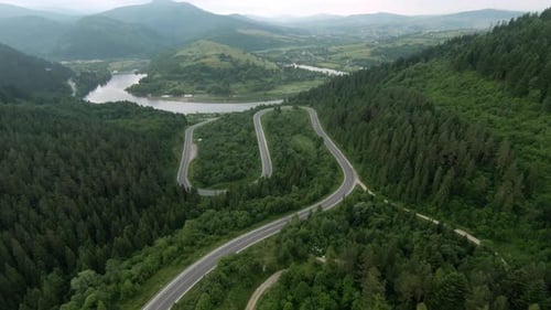A Beautiful and Serene Winding Road That Passes Through a Lush and Vibrant Green Landscape