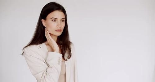 Stylish Woman Posing in Front of White Wall