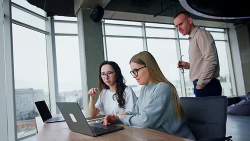 Young Adults Collaborating in Modern Urban Office